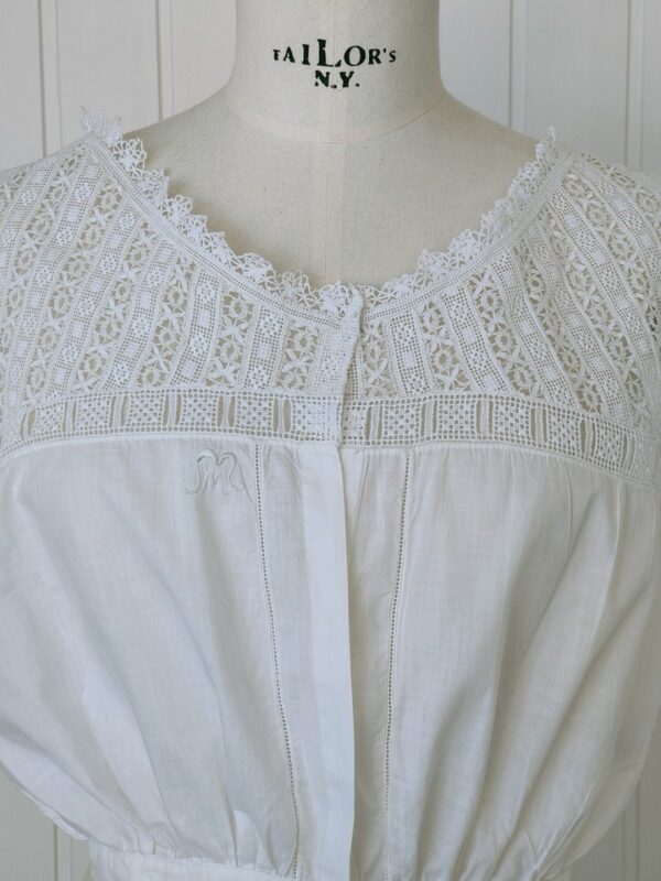 Delicate antique cotton blouse with bobbin lace and embroidered strip.