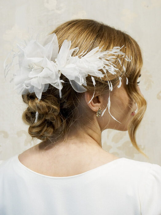 Elegant bridal headdress with white flowers and feathers
