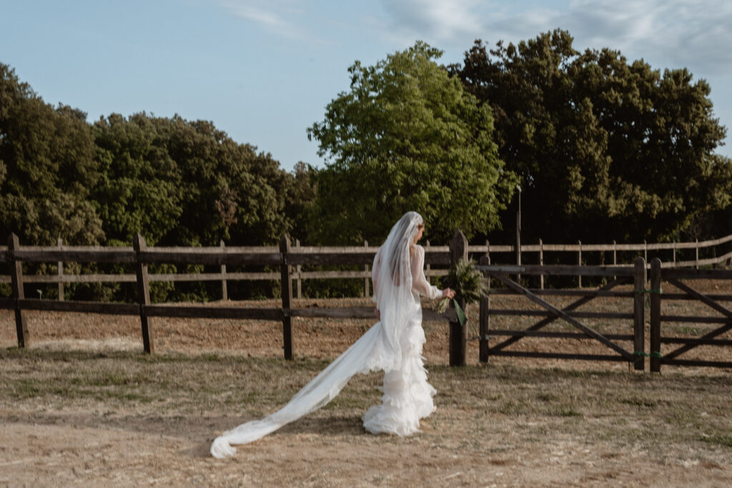 Claudia Aurell wearing a natural silk wedding dress by L'Arca Barcelona